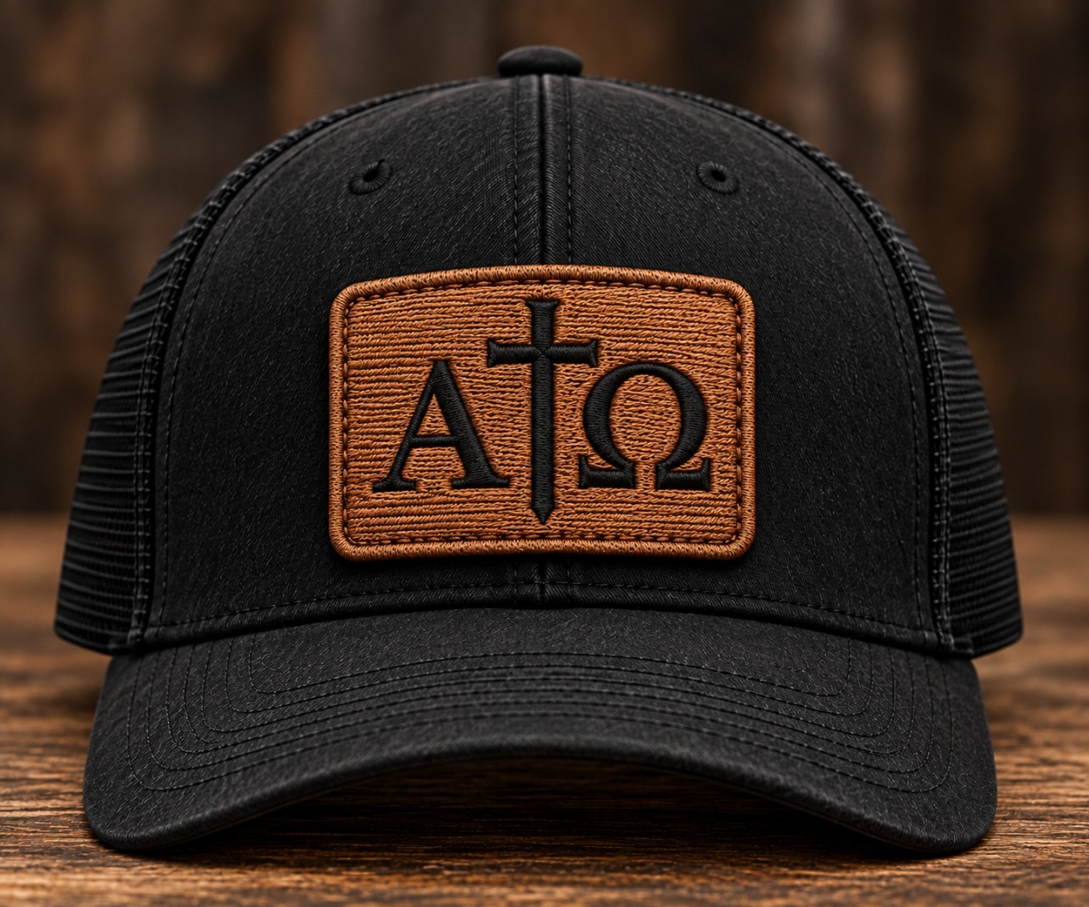Alpha & Omega Hat — black trucker with leather patch embroidery